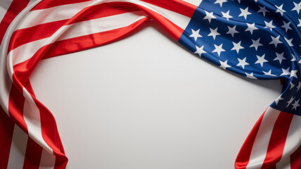 Obraz premium Flowing american flag draped across white background showcasing iconic stars and stripes in fabric, patriotic symbol representing nation.