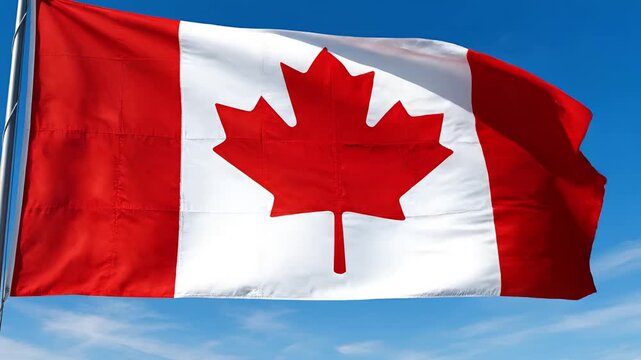 Canadian Flag Waving Proudly Against a Clear Blue Sky.