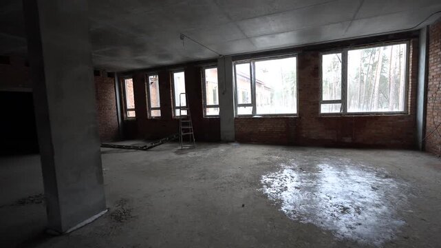 Interior of Empty Commercial Building Under Construction,. Camera Pan of Spacious Raw Concrete Room in New Development