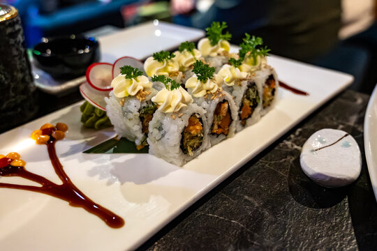 Perfect decorated Japanese sushi rolls with crunchy fried tempura vegetables, vegetarian sushi, vasabi and mayonnaise