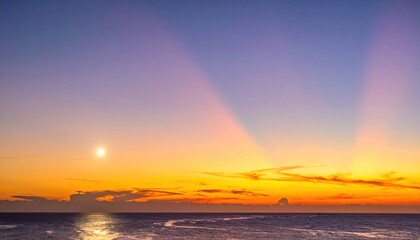 Fototapeta premium Sunset over calm ocean waves horizon.