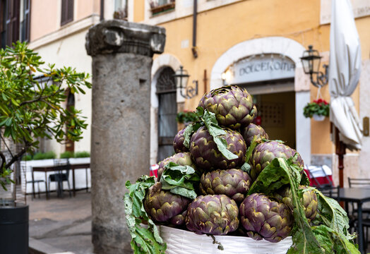 Fresh artichokes by entrance in kosher restaurant in Jewish Quarter of Rome in the Sant'Angelo neighborhood, ingredient of Jewish-style Roman artichokes or carciofi alla giudia