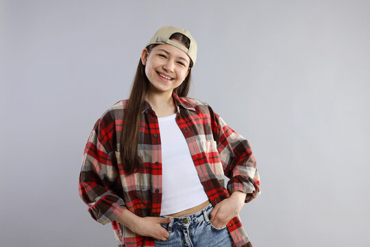 Portrait of beautiful teenage girl on grey background