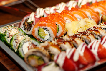 Assorted sushi rolls with salmon, avocado, and tuna © 9parusnikov