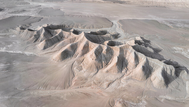 Aerial View of Arid Desert Landscape with Unique Mud Volcanoes and Rocky Terrain