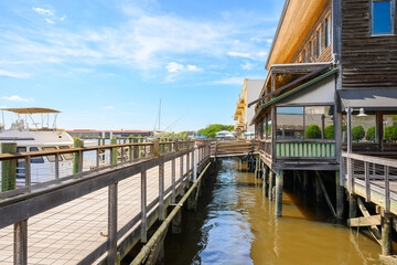Rustic waterfront buildings with pirate themed cafes and shops along the historic Harborwalk at the town of Georgetown, South Carolina, one of the oldest towns in the Carolinas of Southern USA. © Kirk Fisher