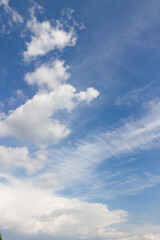 Obraz premium Blue sky with cumulus and cirrus clouds on a summer day vertical natural background