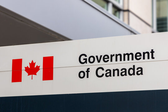 Government of Canada official building sign in Ottawa. Canadian federal signage with flag