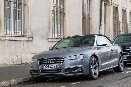 Nancy, France - April 2nd 2022 : View on a grey Audi S5 Cabriolet parked on a street with buildings in the background and in the rain.