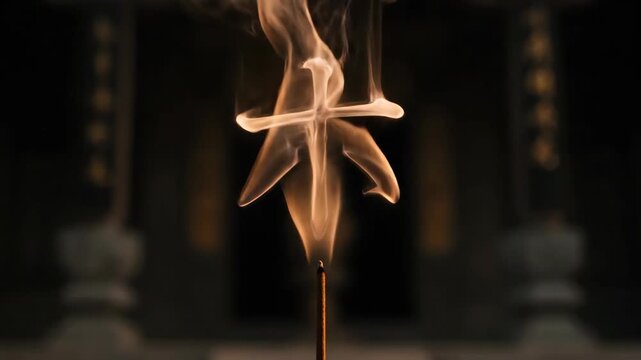 Incense stick releasing thin wisps of smoke forming a Chinese character for wood. Ritual concept of meditation and spirituality in traditional sacred practice.
