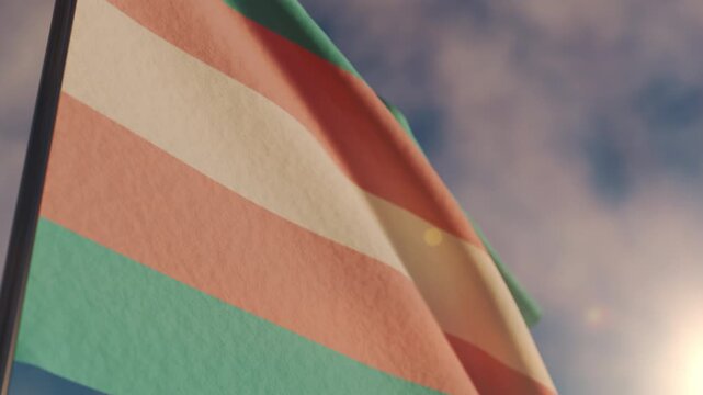 Transgender flag waves in the air at sunset for Pride month