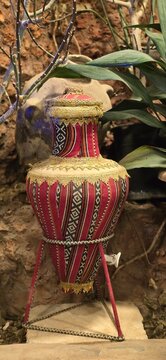     Traditional Arabic Decorative Pottery Jar covered with Sadu Fabric and Golden Embroidery.