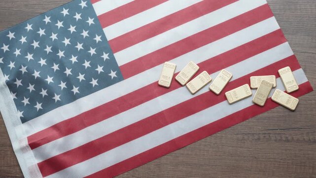 Gold Bars on American Flag Close-up - USA Wealth and Economy Concept