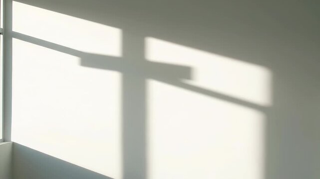Sunlight forming a cross shadow on a white wall. Geometric light projection evolving in a room. Minimalist interior background for spiritual or religious concept.