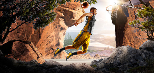Basketball. A basketball player practices on a basketball court in the wilderness. A beautiful landscape is in the background. © 103tnn
