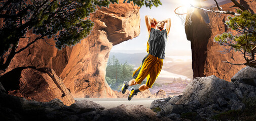 Basketball. A basketball player practices on a basketball court in the wilderness. A beautiful landscape is in the background. © 103tnn