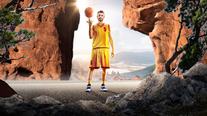 Basketball. A basketball player practices on a basketball court in the wilderness. A beautiful landscape is in the background. © 103tnn
