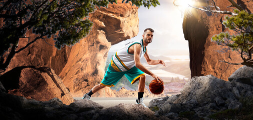 Basketball. A basketball player practices on a basketball court in the wilderness. A beautiful landscape is in the background. © 103tnn
