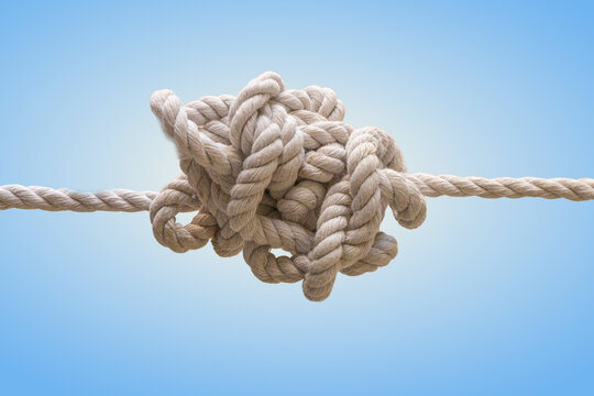 Complex tangled rope knot concept.tightly tangled rope knot isolated on blue background symbolizing complexity, confusion, problem solving and challenge in business or life situations.