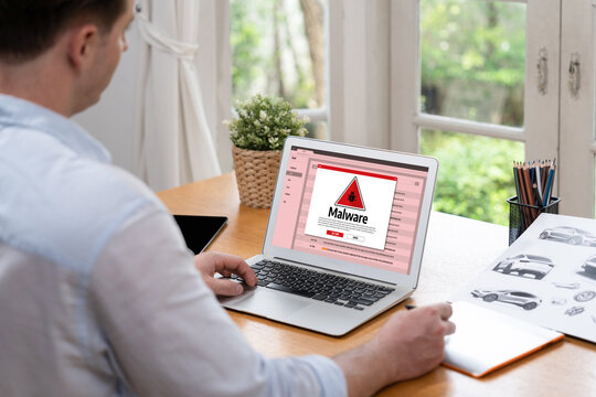 Cyber attacking concept. Malware alert showing on computer screen display scam and threat detection on computer system or online server to be removed brisk.