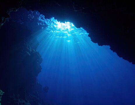 Blue underwater light rays through sea water, dark ocean depths with soft cloudlike particles for science and travel use