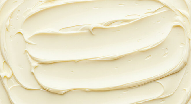 A close-up of smooth, creamy white frosting with soft swirls and gentle ridges.