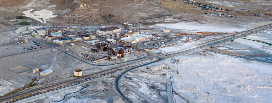 Aerial view of the industrial mining facility at Searles Lake with white mineral deposits and storage tanks in the desert landscape San Bernardino County, California, United States.