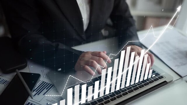 A business professional focuses on financial data displayed on a laptop screen, showcasing graphs and charts that indicate growth and trends in a sleek office setting. Copula
