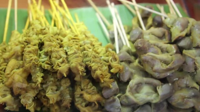 various chicken offal satays on banana leaves, Indonesian street food ready to be grilled or served.