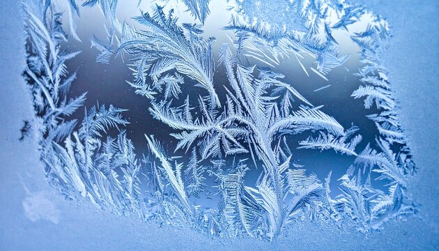 Intricate frost patterns on a window pane creating a winter wonderland.