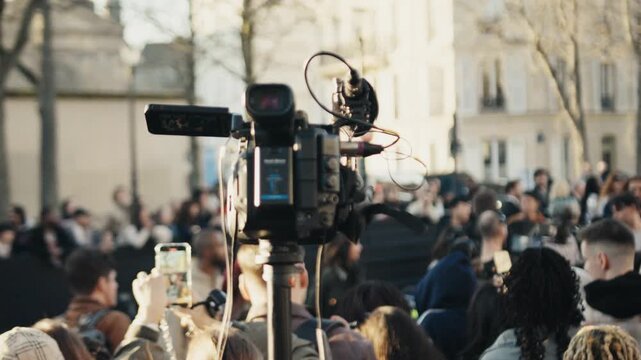 Professional video camera recording a live public event