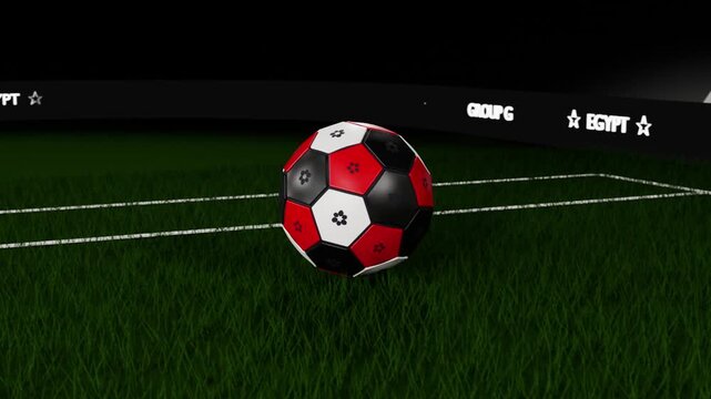 Rotating red-black soccer ball descending onto turf, slowing as camera pulling back, EGYPT GROUP G