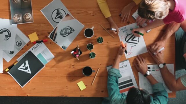 Top view of manager writing idea on sticky notes and explain idea about web design. Professional marketing team or programmer brainstorming idea while looking at tablet with color palette. Symposium.