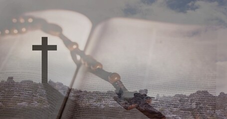 Naklejka premium Displaying open religious book with wooden rosary and crucifix lying on surface, rocky ridge cross