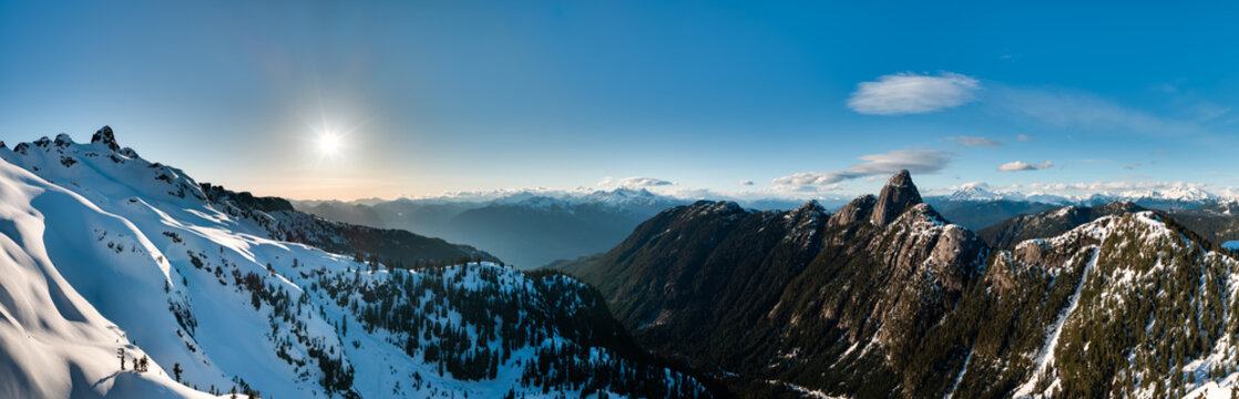 Sunlit Snowy Mountain Panorama Over Rugged Peaks in British Columbia, Canada at Sunset