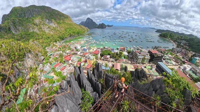 Tourists experiencing an exhilarating zipline adventure high above the lush green landscape of Las Cabanas Beach and the sparkling blue waters of Bacuit Bay in El Nido, Palawan island of Philippines