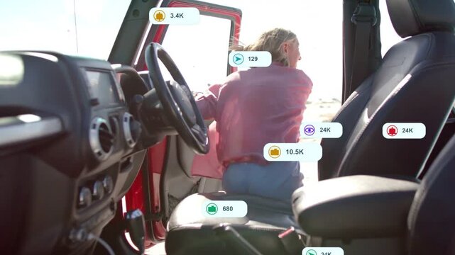 Driver exiting red jeep after opening door to greet friend, social-media icons piling