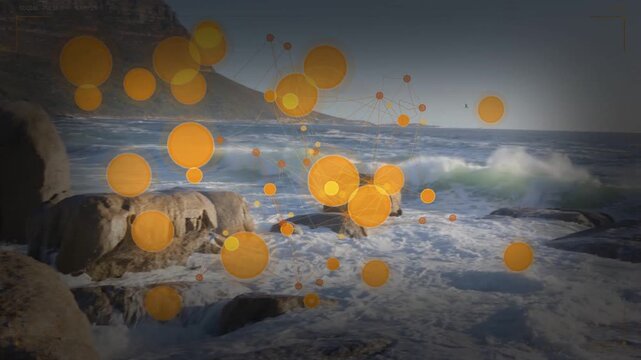 Large wave crashing against coastal rocks, causing orange nodes appearing and linking, forming web