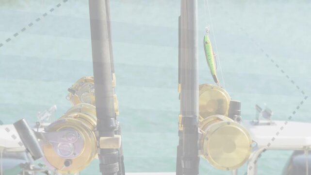Two fishing rods and gold reels standing in holders while wind and boat sway moving lure