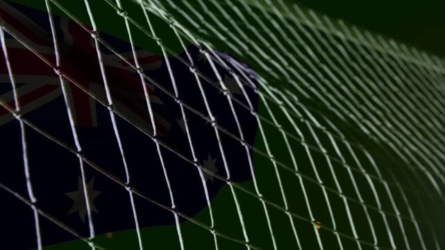 Soccer goal net rippling, bulging as ball striking from right, showing goal with Aussie flag behind