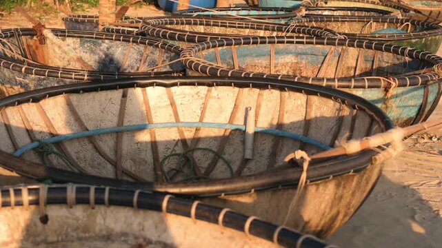 Sunlit Coracle Baskets On Da Nang Vietnam Beach Closeup Of Round Woven Boats On Sand Warm Golden Light Rope Bindings Weathered Texture Low Angle Shadow Play Coastal Mood