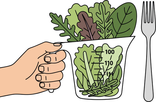 A hand holding a measuring cup filled with fresh green salad leaves and a metal fork next to it