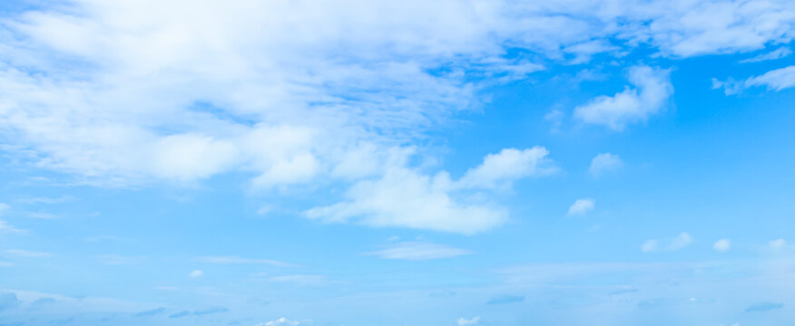 Panoramic bright blue sky with white clouds background and copy space natural cloudscape texture in sunny summer daylight