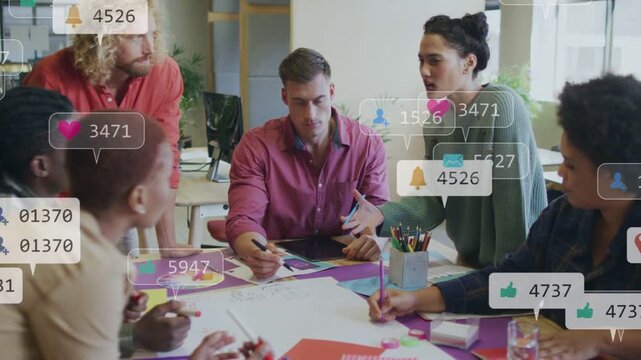 Team marking sheet, causing social alerts flooding frame while designer sketching on tablet for ads