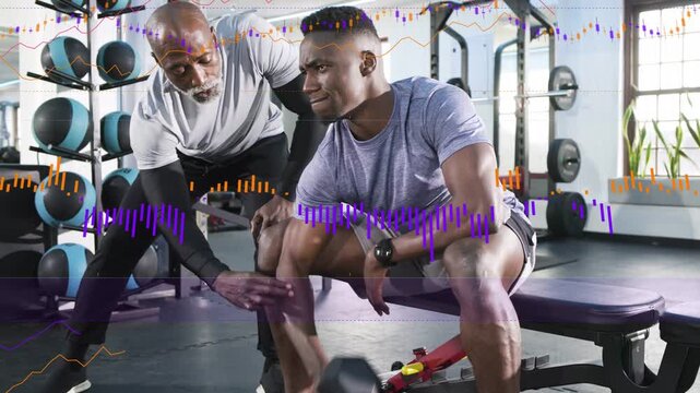 Trainer cueing and adjusting wrist while trainee doing dumbbell curls in gym, waveform guiding form