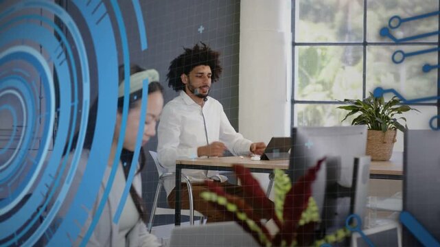 Developer adjusting headset on call, typing on tablet fixing bug, code UI rings linking desks