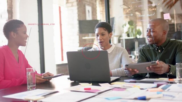 Three colleagues collaborating in business, left woman presenting tablet, center typing on laptop