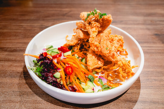Crispy battered squid on a white plate.