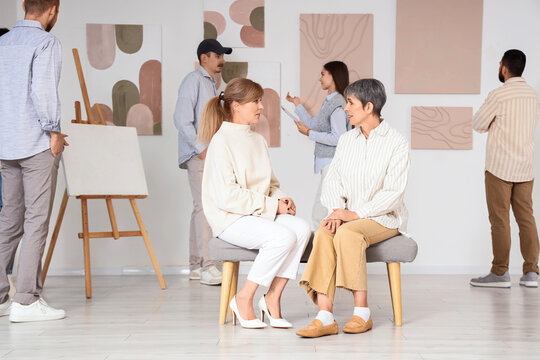 Group of people at art gallery exhibition
