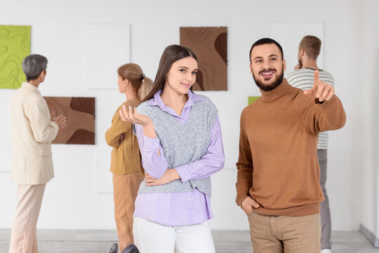 Young people at exhibition in art gallery